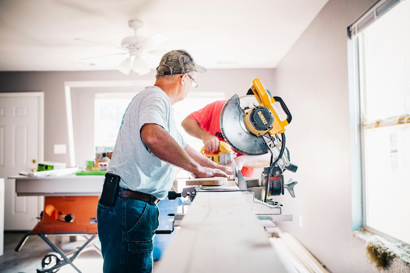 Carpenter cutting trim during a home renovation